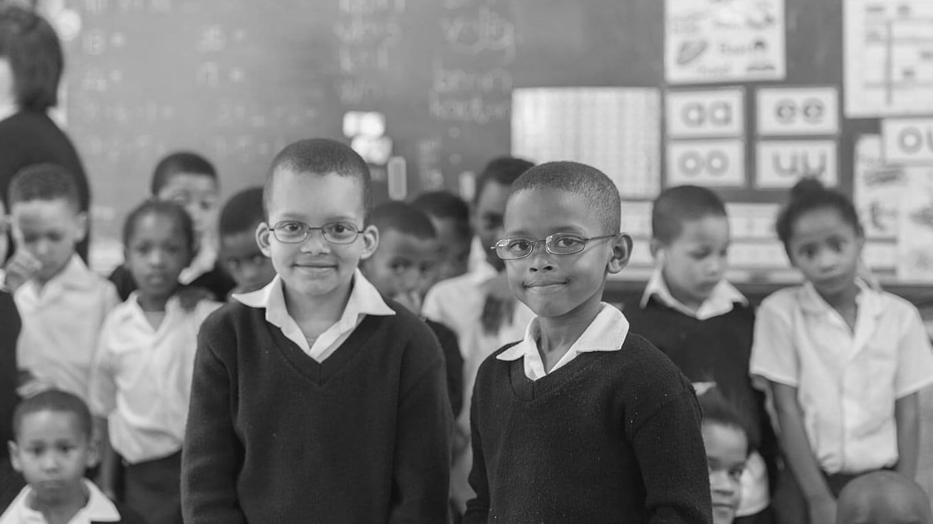 Kids wearing glasses in classroom